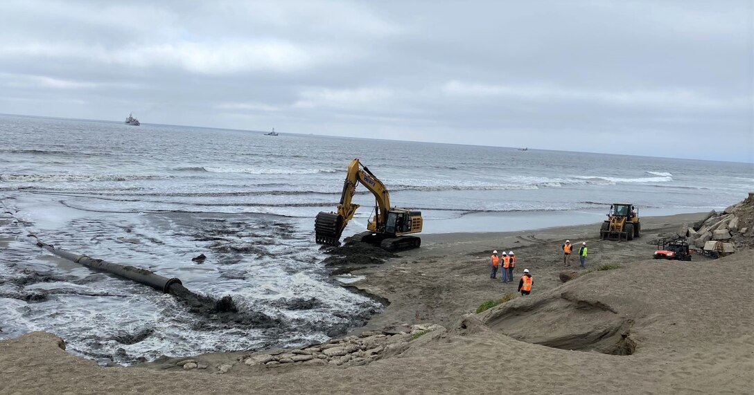 Sand, beach, ocean and construction equipment