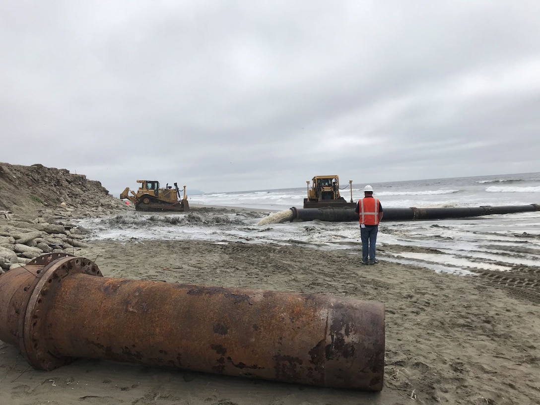 Sand, beach, ocean and construction equipment