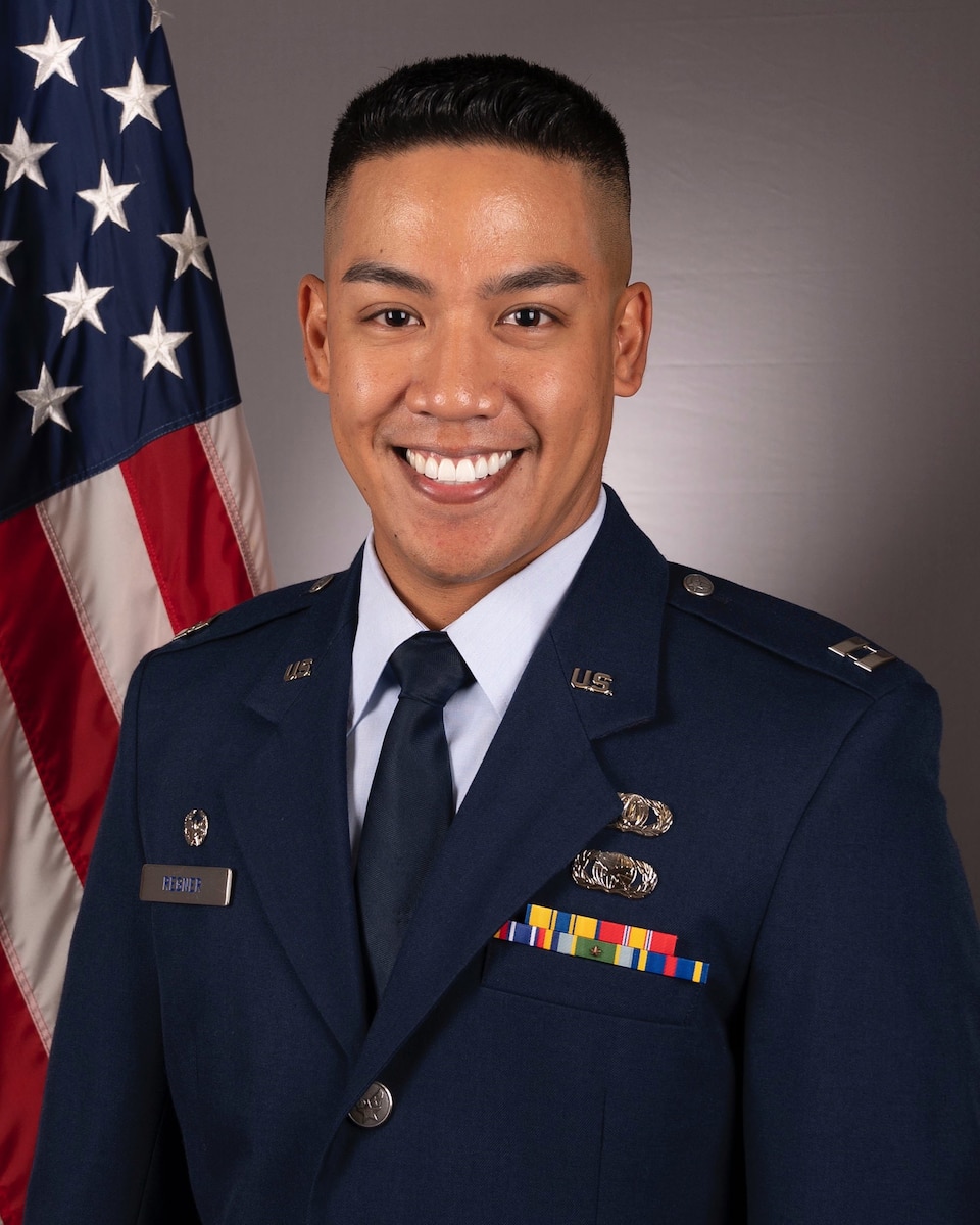 Official photo of Captain David Neil C. Regner, Commander of both the United States Air Force (USAF) Heritage of America Band based in Langley AFB, Virginia and the USAF Heartland of America Band based in Offutt AFB, Nebraska.  Captain Regner is wearing blue service dress in front of an American flag background.