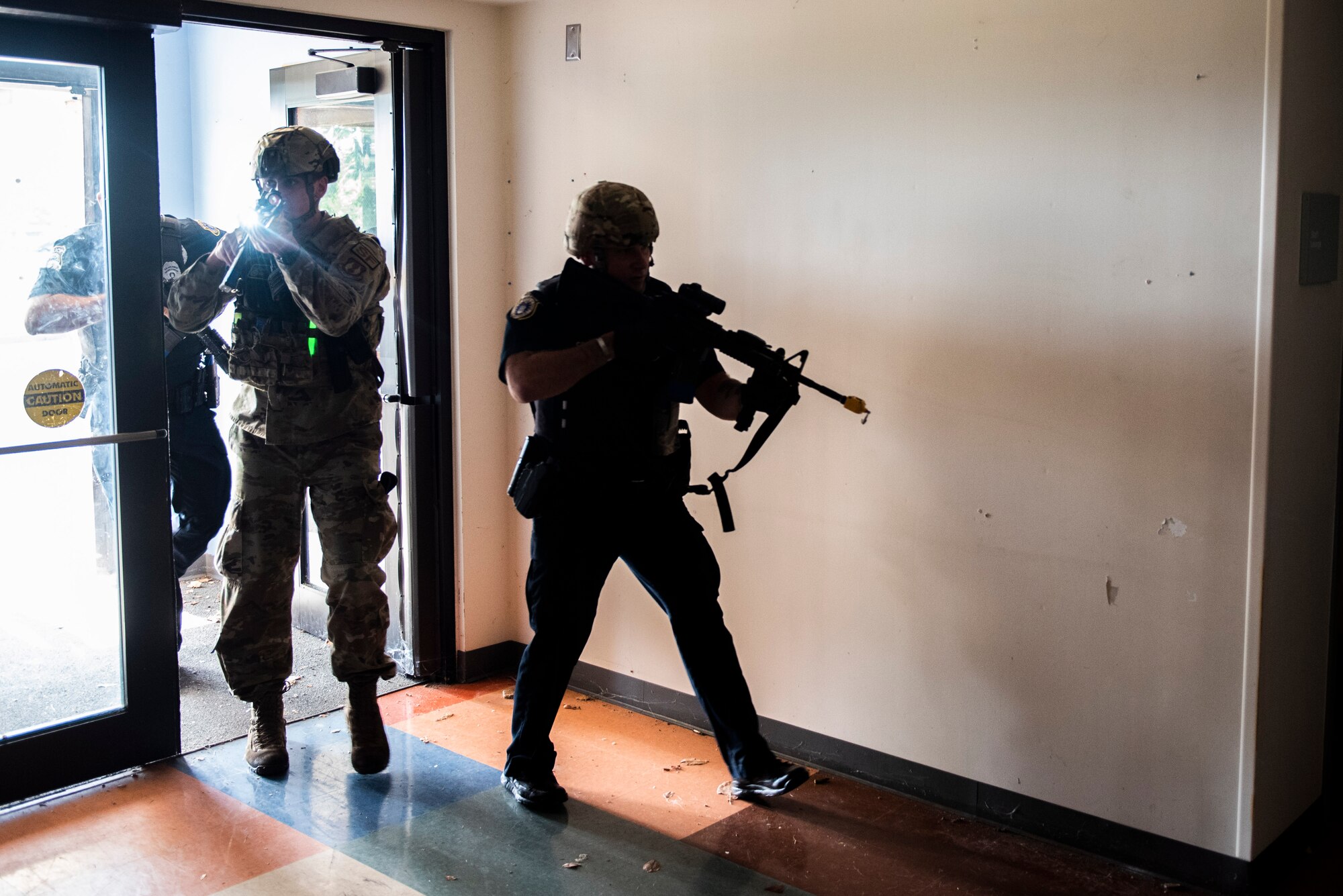 Members of the 88th Security Forces Squadron make entry to a building during an active shooter exercise, Aug. 18 at Wright-Patterson Air Force Base. Readiness exercises are routinely held to streamline unit cohesion when responding to emergencies. (U.S. Air Force photo by Wesley Farnsworth)