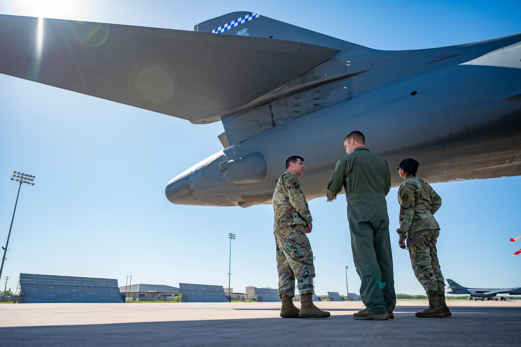 Lt. Col. Nathan Jenkins, 9th Bomb Squadron commander, center, briefs Maj. Gen. Andrew Gebara, 8th Air Force and Joint-Global Strike Operations Center commander, left, and Chief Master Sgt. Melvina Smith, 8th Air Force command chief and J-GSOC senior enlisted leader, while observing a B-1B Lancer on the flightline at Dyess Air Force Base, Texas, Aug. 23, 2021. During his visit, Gebara received several briefings on the B-1’s mission set and combat capabilities. (U.S. Air Force photo by Senior Airman Colin Hollowell)