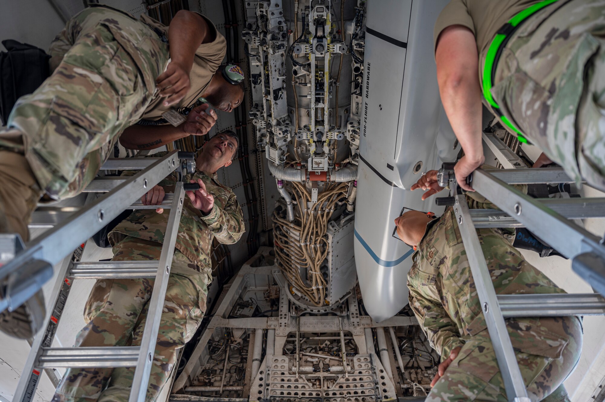 Maj. Gen. Andrew Gebara, 8th Air Force and Joint-Global Strike Operations Center commander, center left, and Chief Master Sgt. Melvina Smith, 8th AF command chief, center right, watch as Airmen assigned to the 7th Aircraft Maintenance Squadron load inert munitions into a B-1B Lancer during a weapons load exercise at Dyess Air Force Base, Texas, Aug. 23, 2021. The B-1 is a long-range strategic bomber capable of delivering precision and non-precision munitions to any location around the globe. (U.S. Air Force photo by Senior Airman Colin Hollowell)