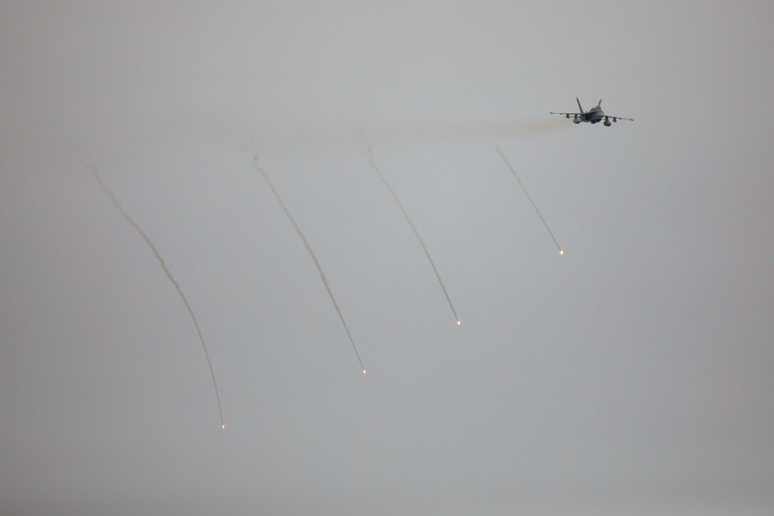 Flares descend after being fired from a nearby aircraft.