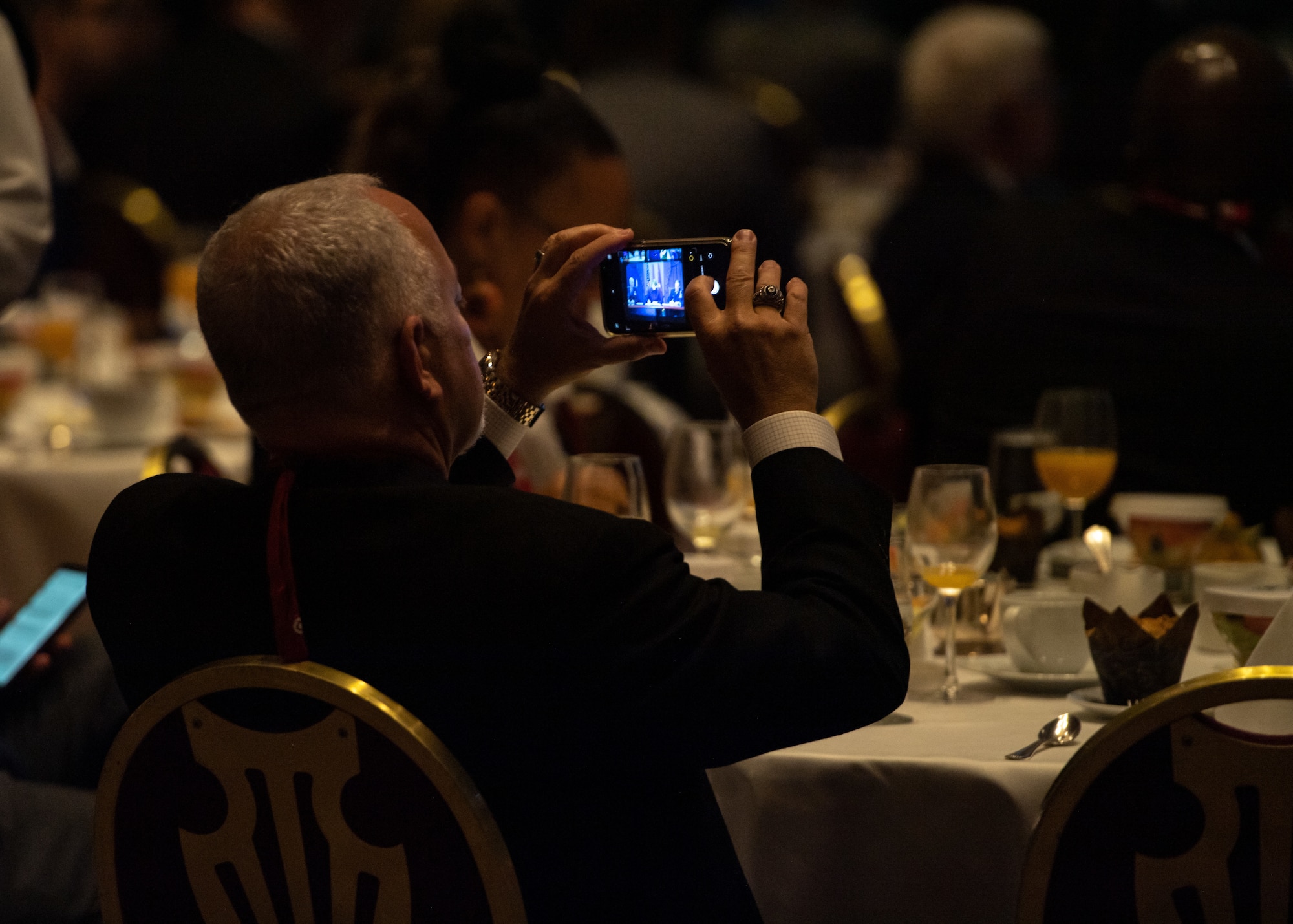 A Space Symposium attendee takes a photo during the Satellite Forum Breakfast in Colorado Hall, on Aug. 25, 2021.