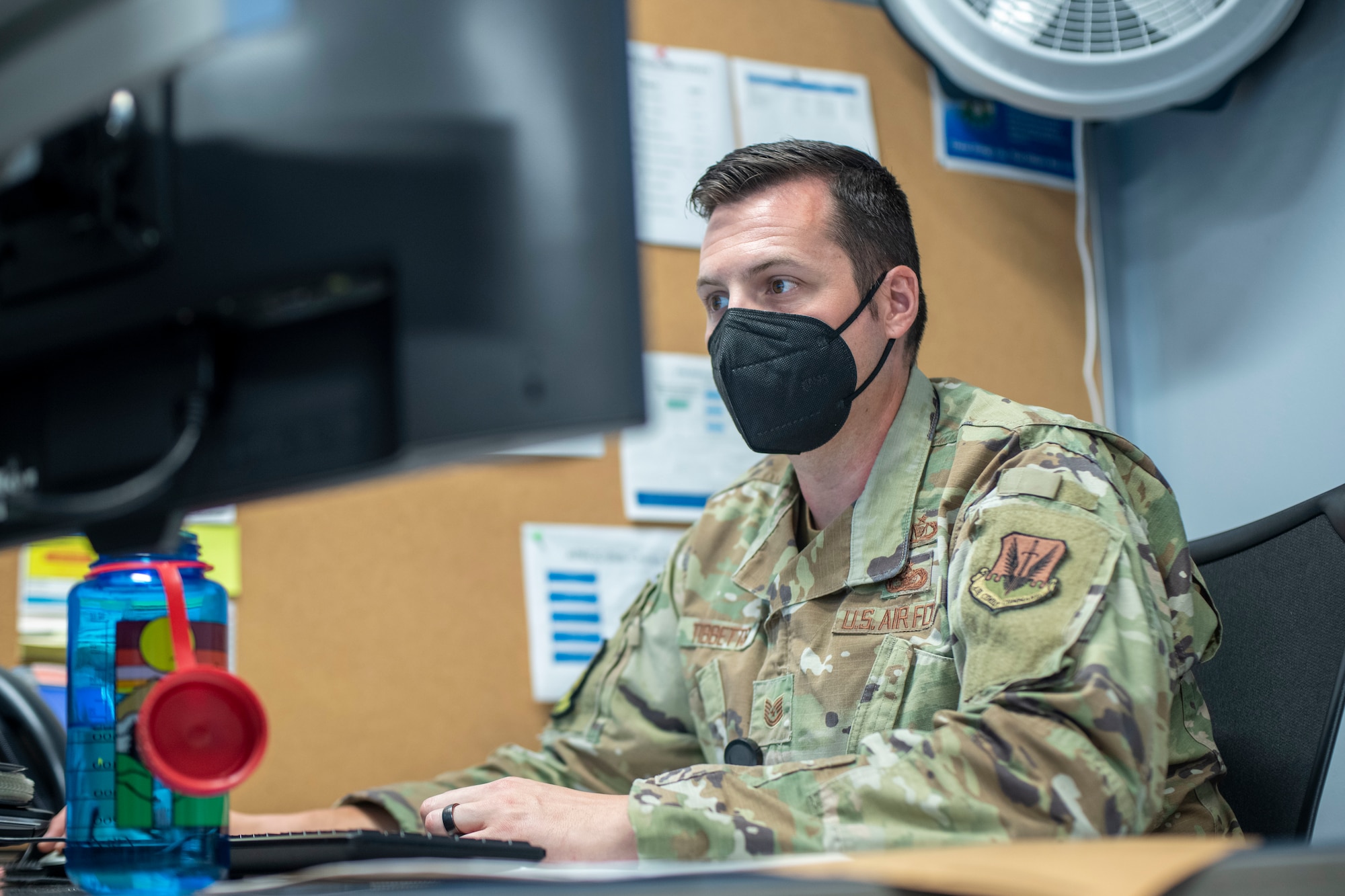 Man sits in front of a computer