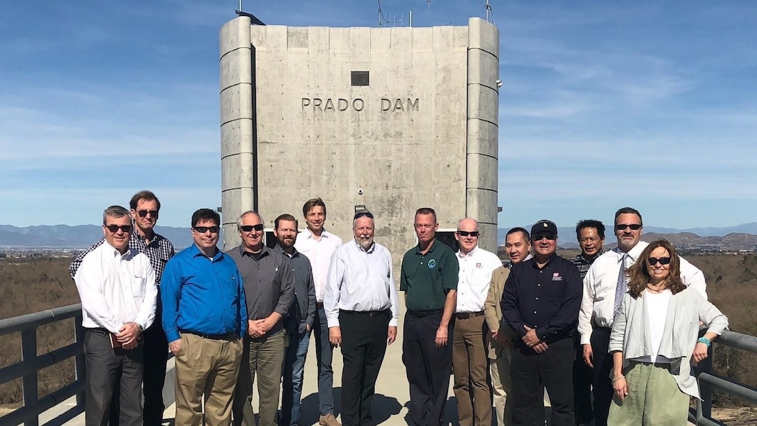 The Prado Dam steering committee for the Forecast-Informed Reservoir Operations (FIRO) pilot program pose for a picture while touring the structure.
