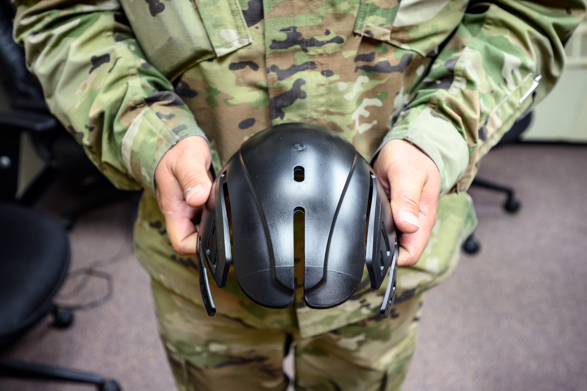 U.S. Air Force Master Sgt. Ryan Smith, 354th Fighter Wing flight safety non-commissioned officer, displays a bump cap prototype Aug. 24, 2021, at Eielson Air Force Base, Alaska. The bump cap, a thin plastic covering designed to fit inside authorized baseball-style tactical caps, aids in keeping maintainers safe from head injuries during the performance of their duties. (U.S. Air Force photo by Staff Sgt. Christian Conrad)