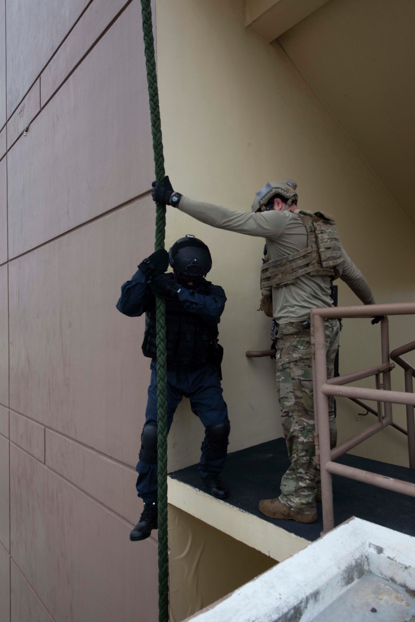 A U.S. Naval Special Warfare operator holds a rope for a Japan Maritime Self-Defense Force sailor as part of MALABAR 2021. MALABAR 2021 is an example of the enduring partnership between Australian, Indian, Japanese and American maritime forces, who routinely operate together in the Indo-Pacific, fostering a cooperative approach toward regional security and stability. Naval Special Warfare is the nation’s premiere maritime special operations force and is uniquely positioned to extend the Fleet’s reach and deliver all-domain options for naval and joint force commanders.
