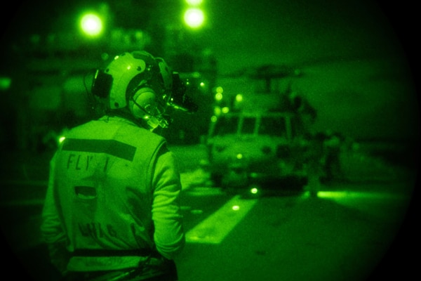 Aviation Boatswain’s Mate (Handling) Airman Jesse Click, from Sylvan Springs, Ala., assigned to the forward-deployed amphibious assault ship USS America (LHA 6), signals an MH-60S Seahawk helicopter from the Helicopter Sea Combat Squadron (HSC) 25. America, flagship of the America Expeditionary Strike Group, along with the 31st Marine Expeditionary Unit, is operating in the U.S. 7th Fleet area of responsibility to enhance interoperability with allies and partners and serve as a ready response force to defend peace and stability in the Indo-Pacific region.