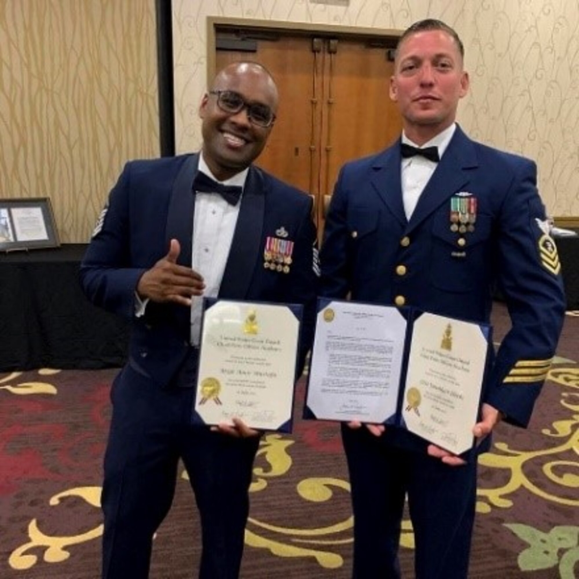 Two service members pose for a group photo.