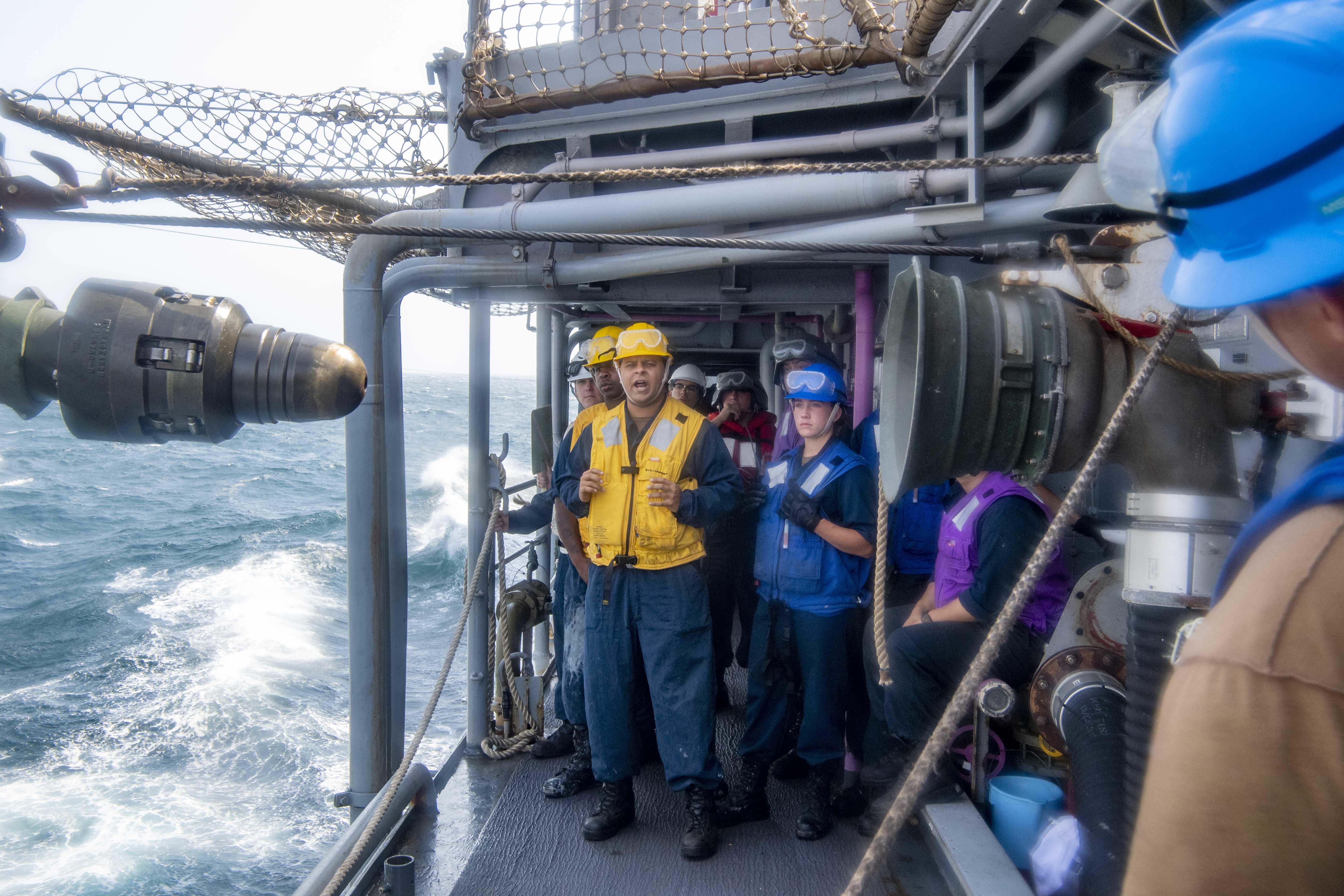 Boatswain’s Mate 2nd Class Nikolai Martinez shouts to line handlers to continue heaving the messenger line to seat the fuel probe aboard the guided-missile cruiser USS Shiloh (CG 67) during a replenishment-at-sea with the Henry J. Kaiser-class underway replenishment oiler USNS Patuxent (T-AO-201) in the Arabian Gulf.