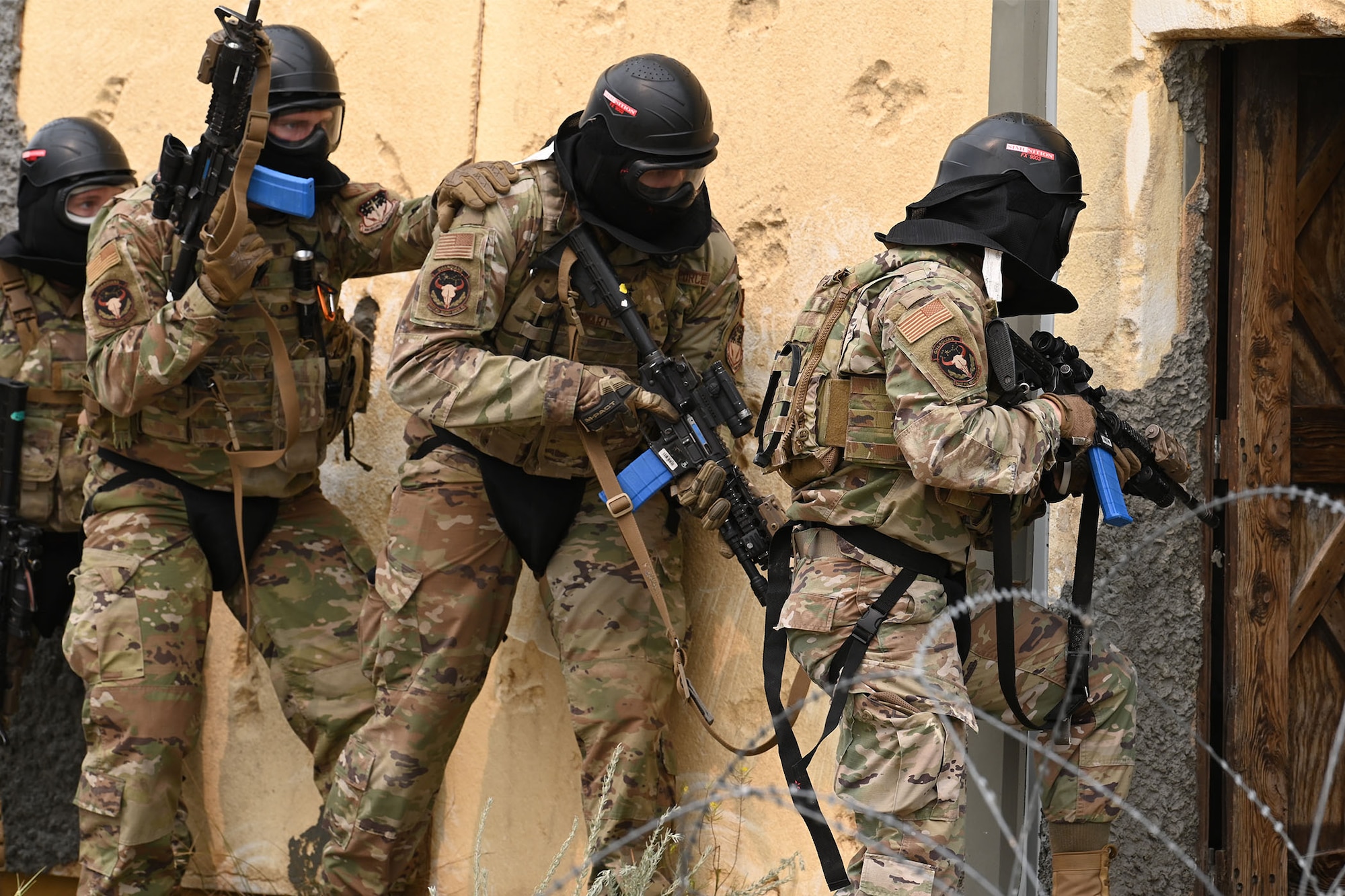 Defenders from the 841st Missile Security Forces Squadron prepare to breach a building during a training exercise Aug. 17, 2021, at the firing range village on Fort Harrison, Mont. Defenders use verbal and nonverbal commands to execute group movements while staying alert with weapons drawn to defend themselves against enemy combatants. (U.S. Air Force photo by Airman Elijah Van Zandt)