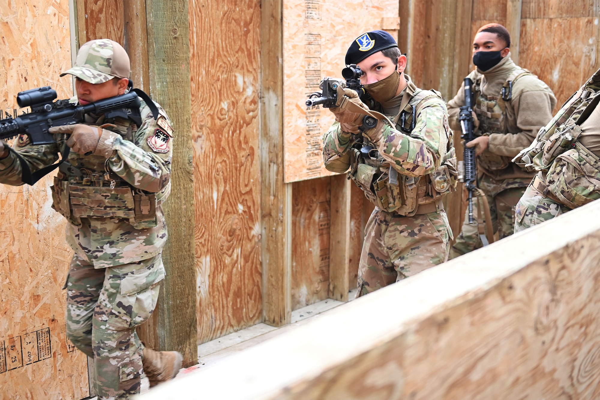 Defenders from the 841st Missile Security Forces Squadron practice breaching techniques during an exercise Aug. 17, 2021, at the base firing range village on Fort Harrison, Mont. Defenders fired training ammunition during the exercise to increase weapon confidence during challenging and stressful situations.  (U.S. Air Force photo by Airman Elijah Van Zandt)