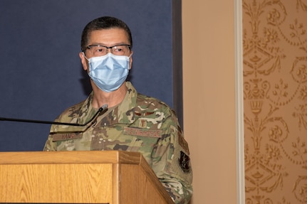 Col. Frank Y. Yang stands at the podium after assuming command of the 192nd Medical Group.