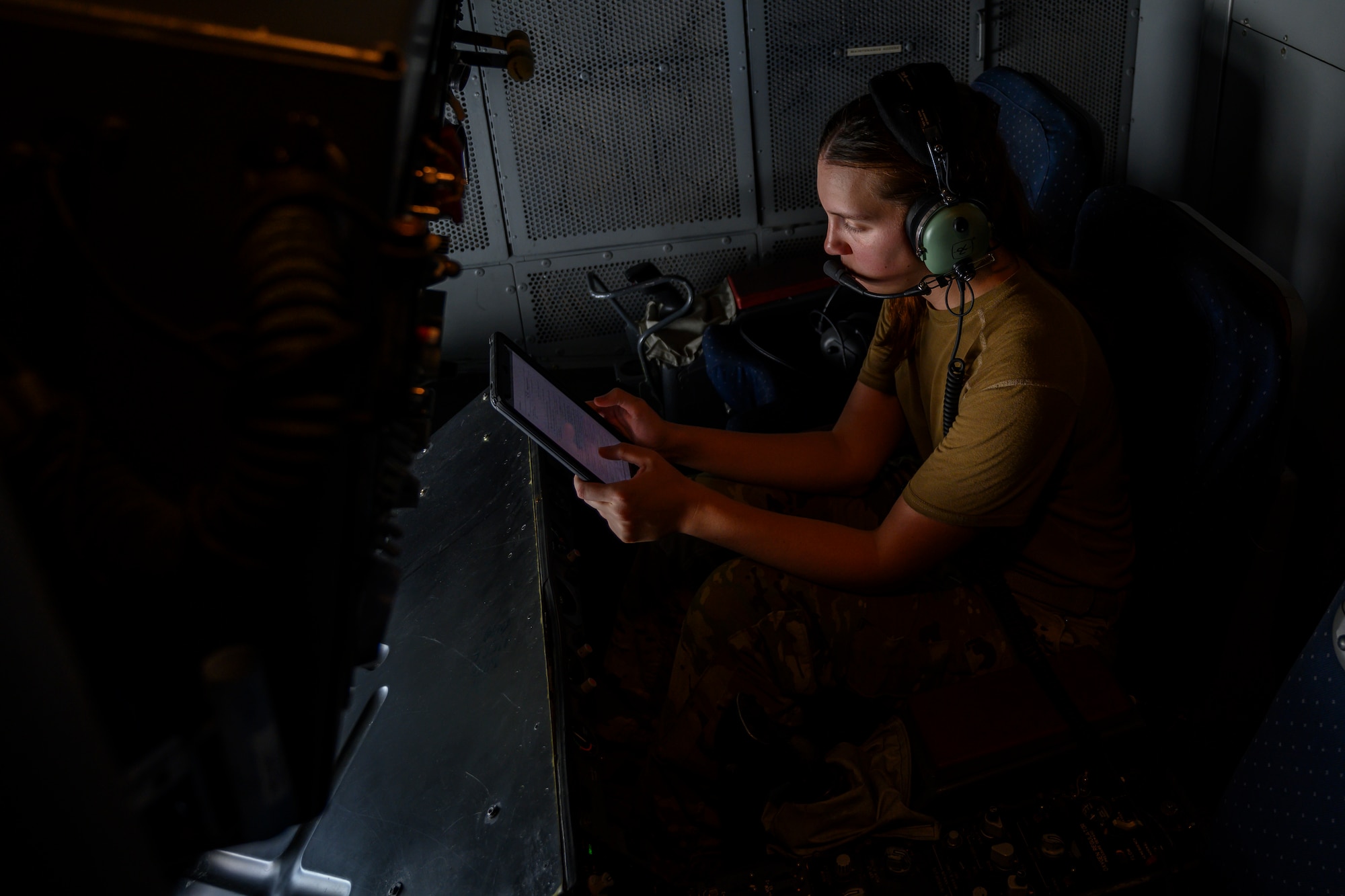 Female airman sitting in aircraft refueling bay