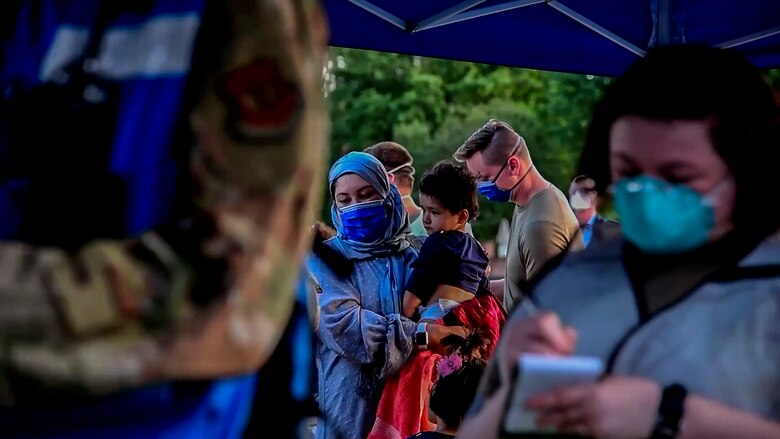 Evacuees wait in line for for medical screening.