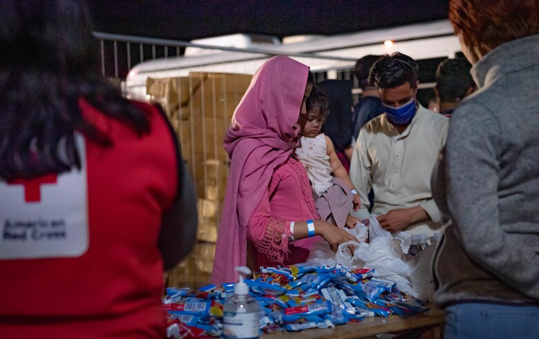 Evacuees receive donated goods.