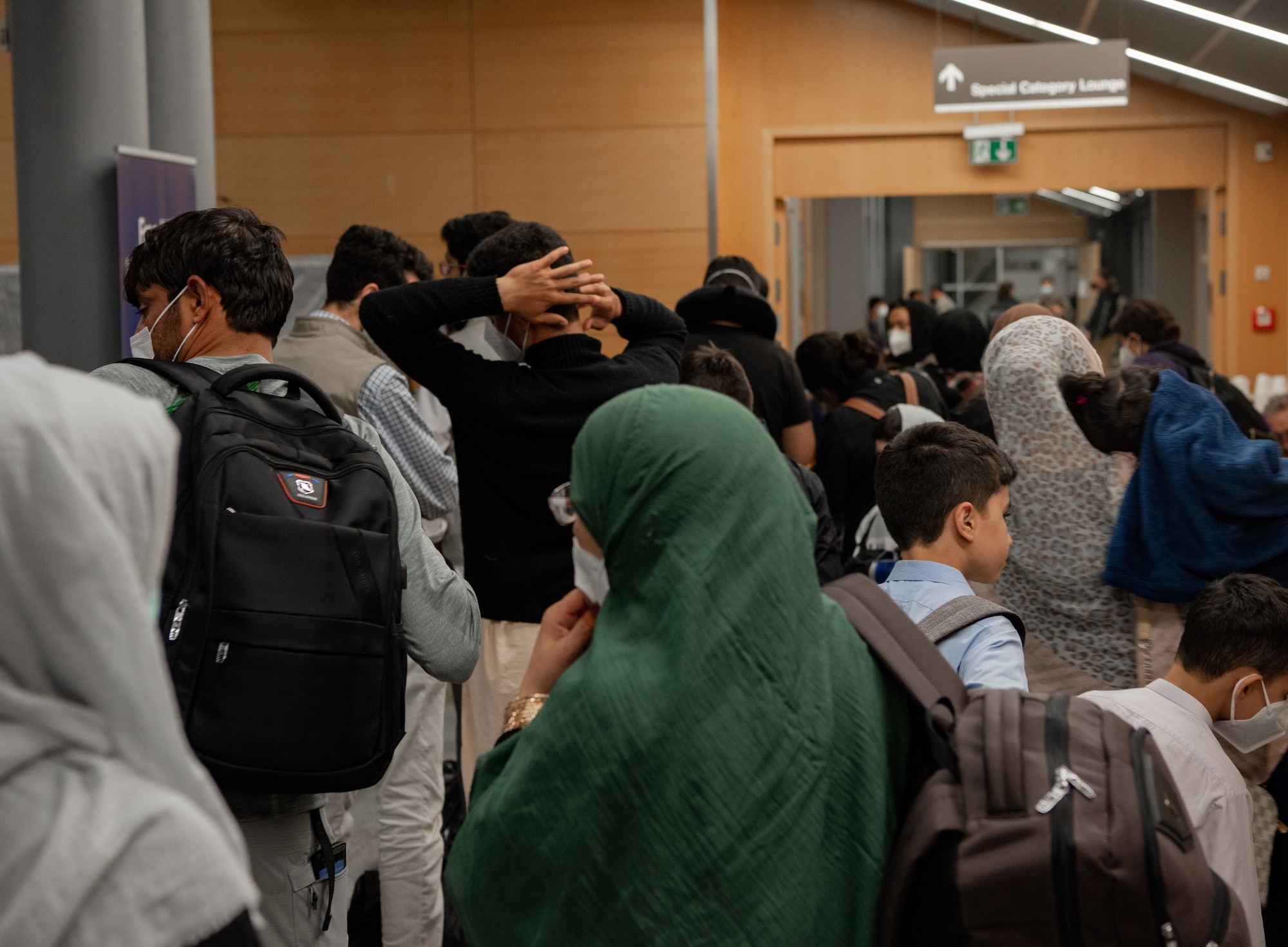 Evacuees walks through passenger terminal.