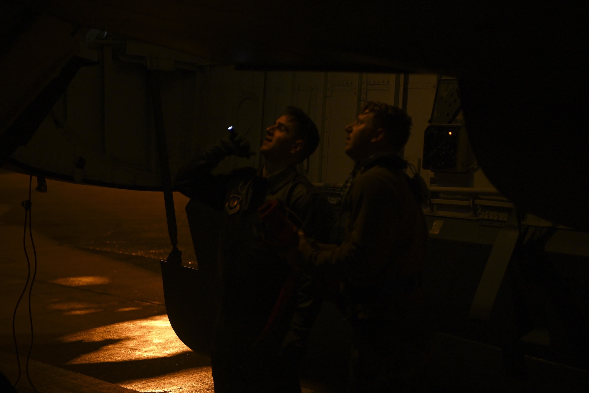 U.S. Air Force Capt. Aaron Bassut, 351st Air Refueling Squadron pilot, left, and an Airman assigned to the 100th Aircraft Maintenance Squadron, inspect a KC-135 Stratotanker aircraft before a mission at Royal Air Force Mildenhall, England, Aug. 24, 2021. The 100th Air Refueling Wing provides unrivaled air refueling support throughout the European and African areas of responsibility. (U.S. Air Force photo by Senior Airman Joseph Barron)