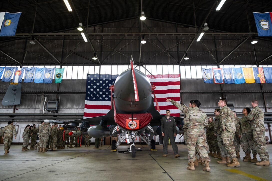 U.S. Air Force noncommissioned officers participating in the Atlantic Stripe Conference listen to briefings about U.S. Air Force F-16 Fighting Falcon fighter jet capabilities and operations during the conference on Spangdahlem Air Base, Germany, Aug. 19, 2021.