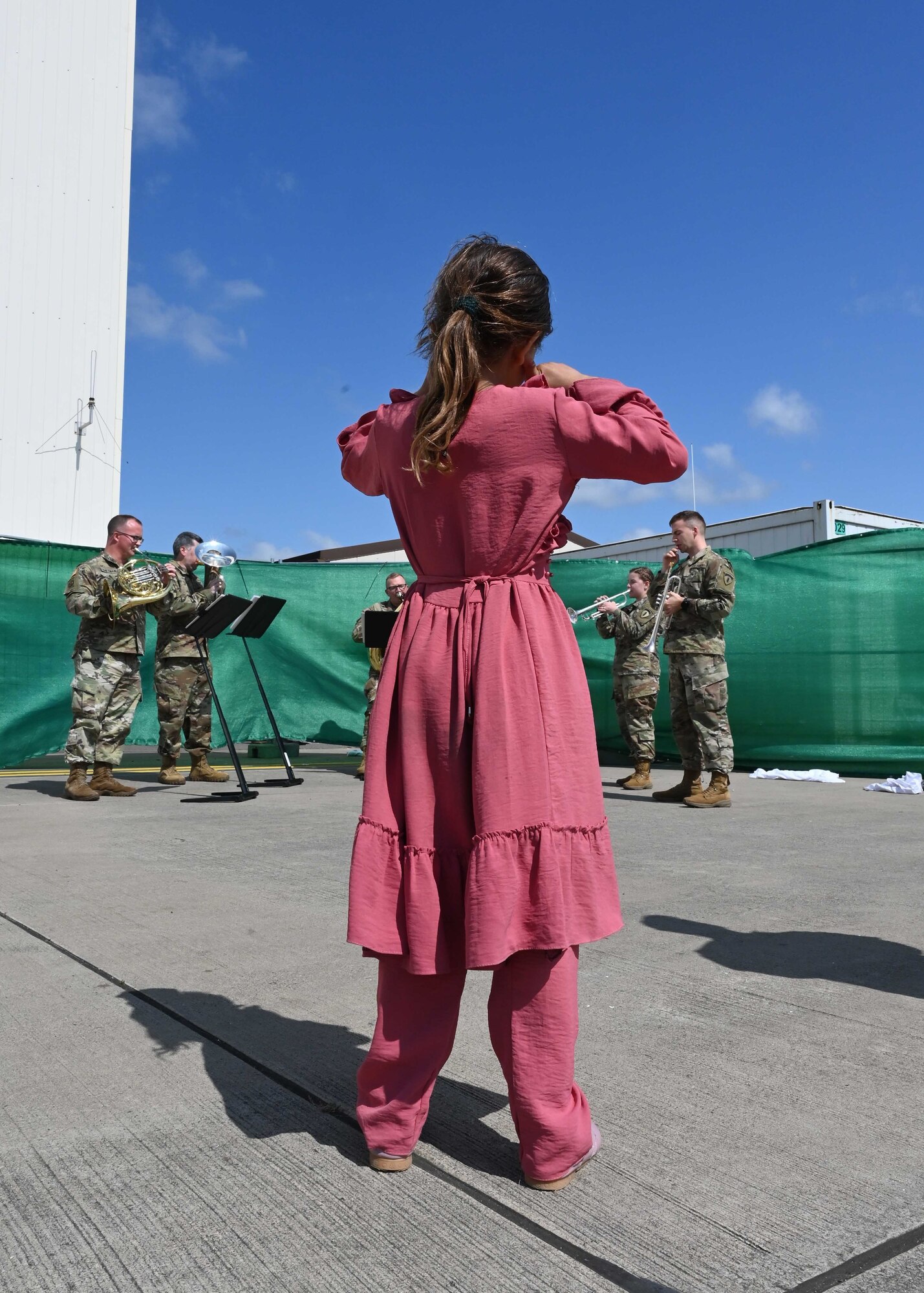 Child evacuee listens to Army band music.