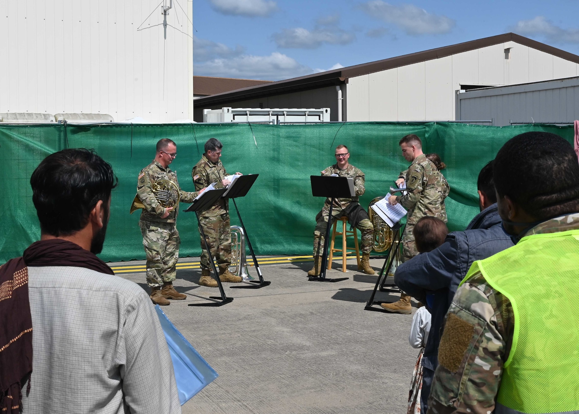Army bands plays music for evacuees.