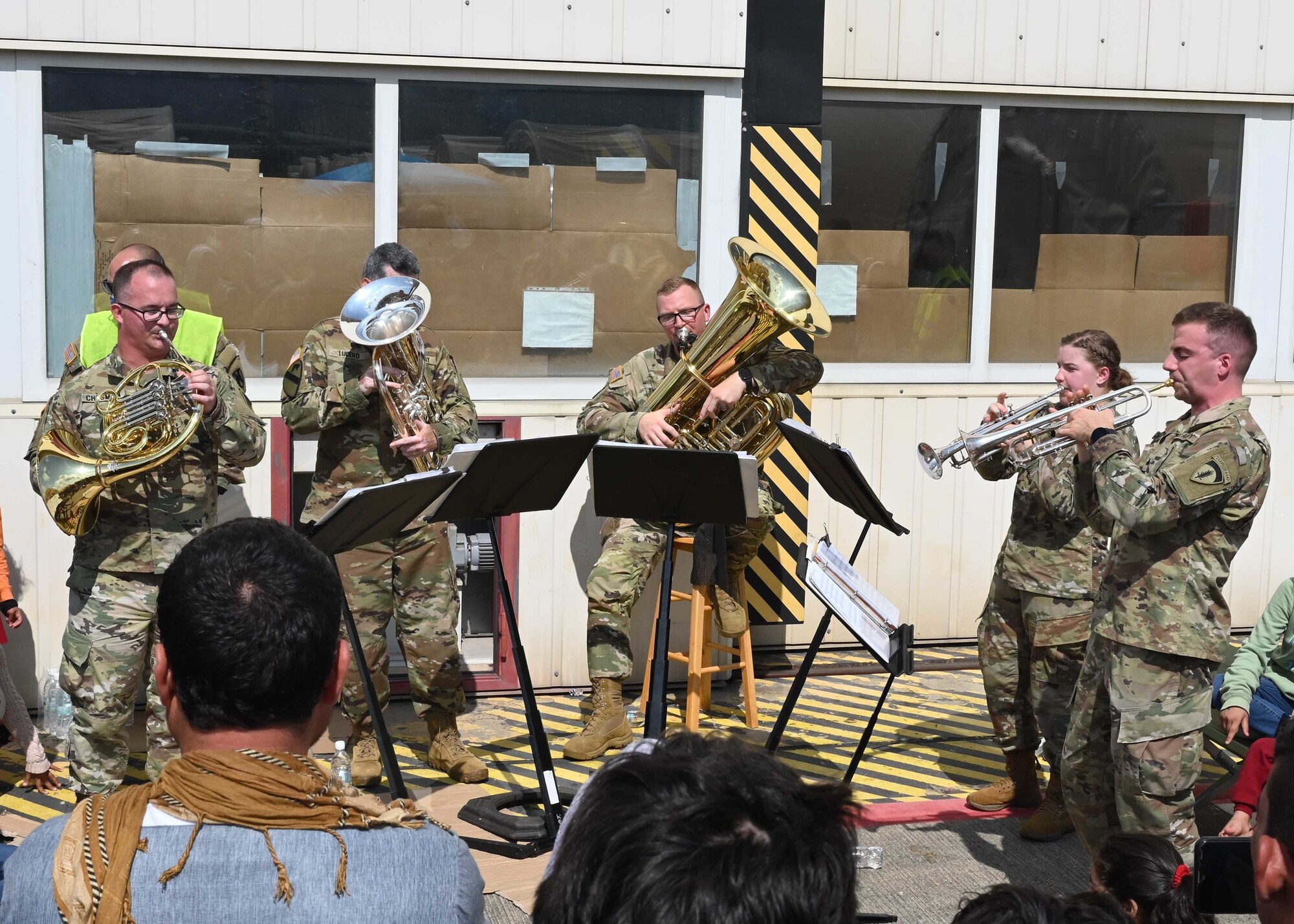 Army band plays music for evacuees.