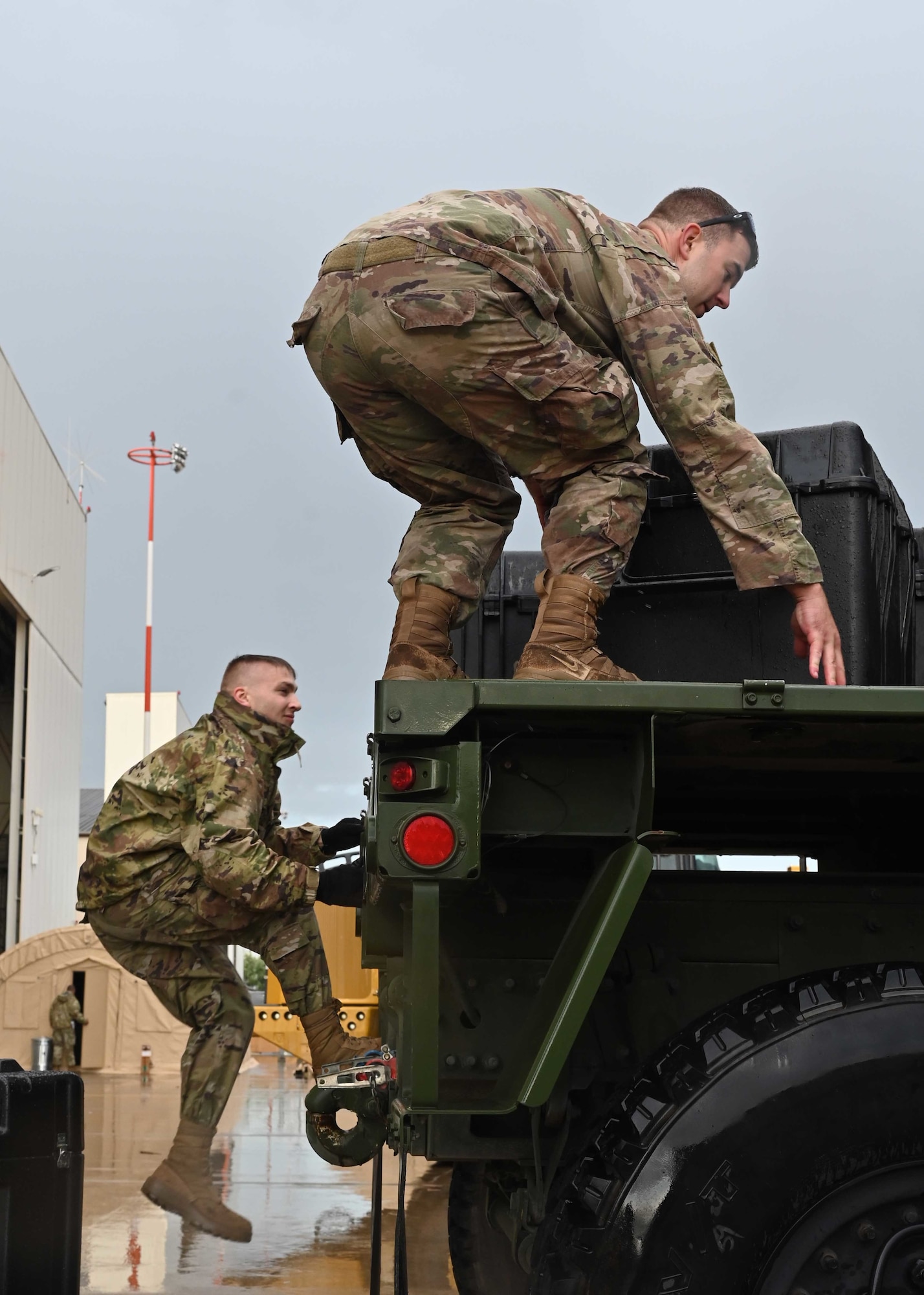 Airmen load cargo on truck.