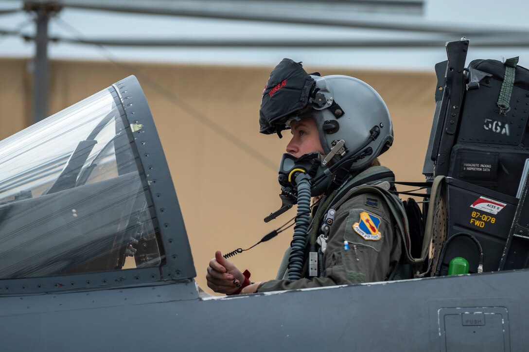 Capt. Lauren Schlichting, 333rd Fighter Squadron evaluating pilot and executive officer, performs and instrument check on an F-15E Strike Eagle at Seymour Johnson Air Force Base, North Carolina, August 4, 2021.