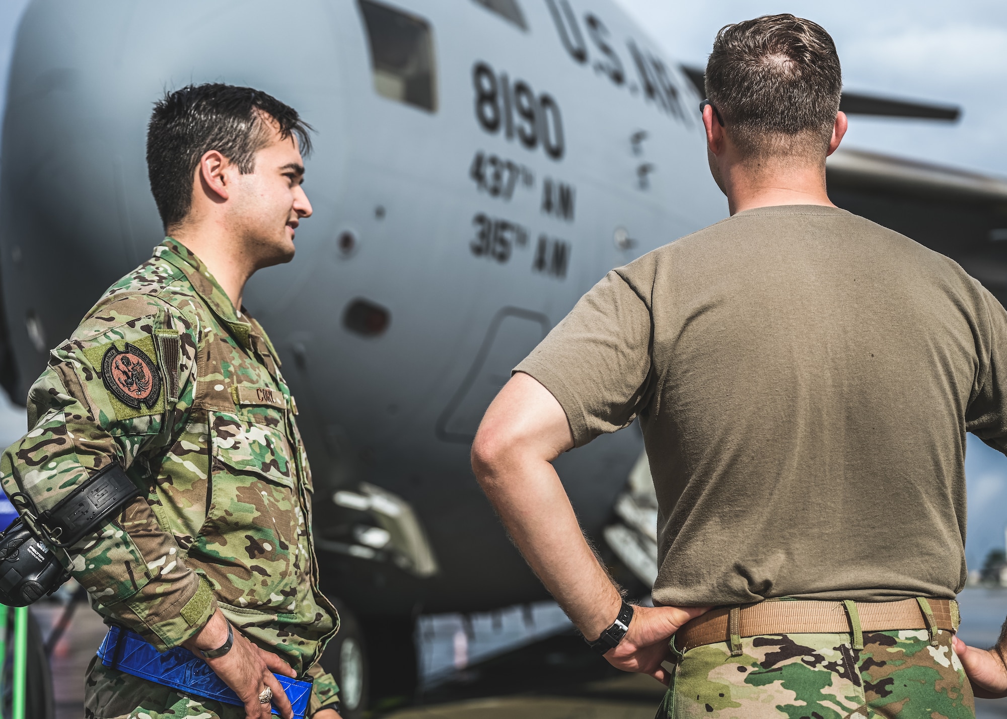 Airmen talk on flightline.