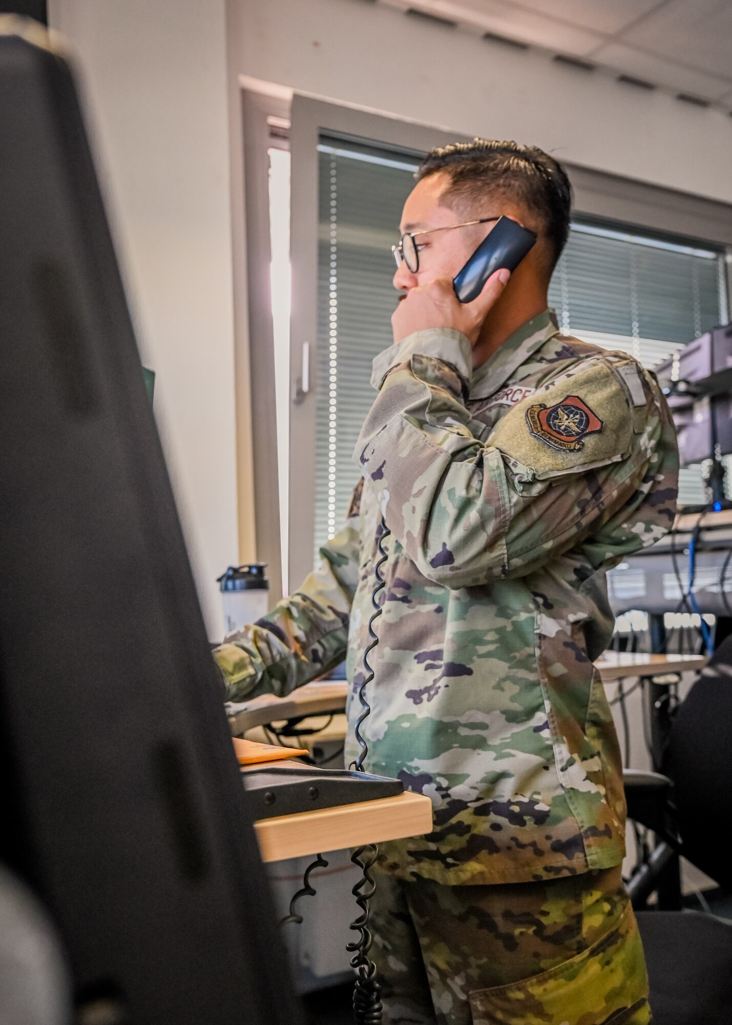 Airman answers phone.