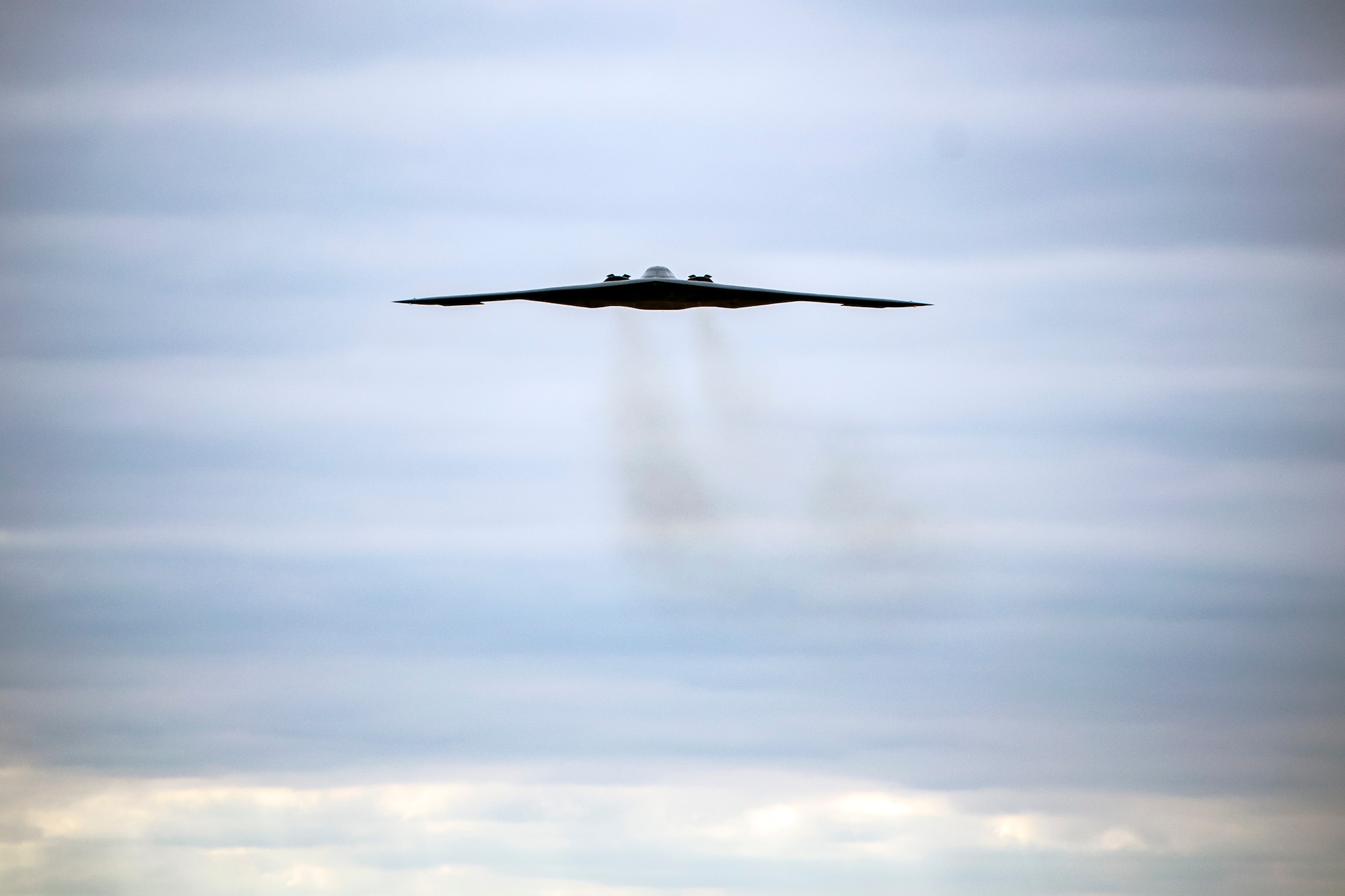 A B-2 Spirit assigned to the 509th Bomb Wing flies overhead at RAF Fairford, England, Aug. 25, 2021. The B-2 flyover was part of a Bomber Task Force mission in which aircraft conduct theater and flight training across Europe and Africa. Strategic bomber missions enable crews to maintain a high state of readiness and proficiency, and validate our always-ready global strike capability. (U.S. Air Force photo by Senior Airman Eugene Oliver)