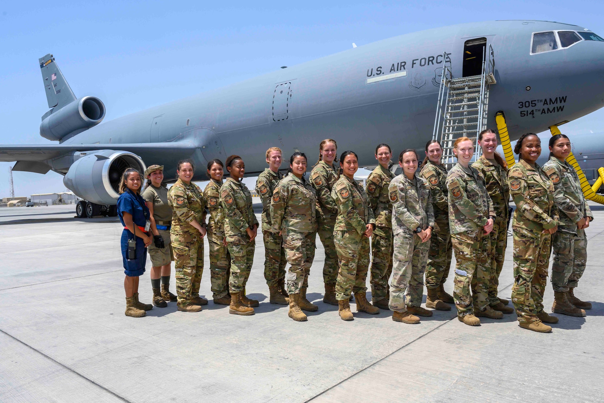 A group of female Airmen pose in front of a KC-10 Extender aircraft