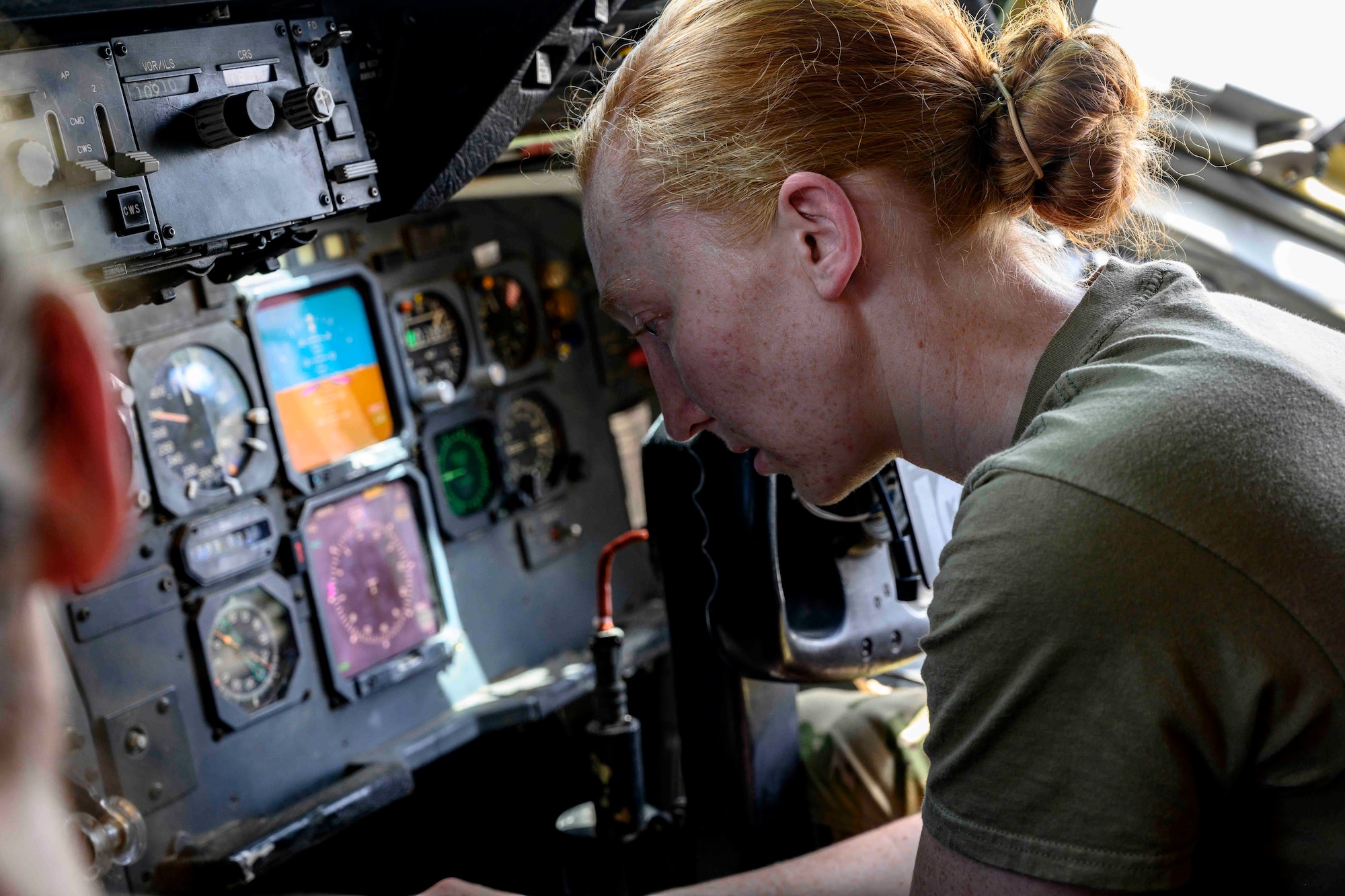 Female pilot in cockpit of aircraft