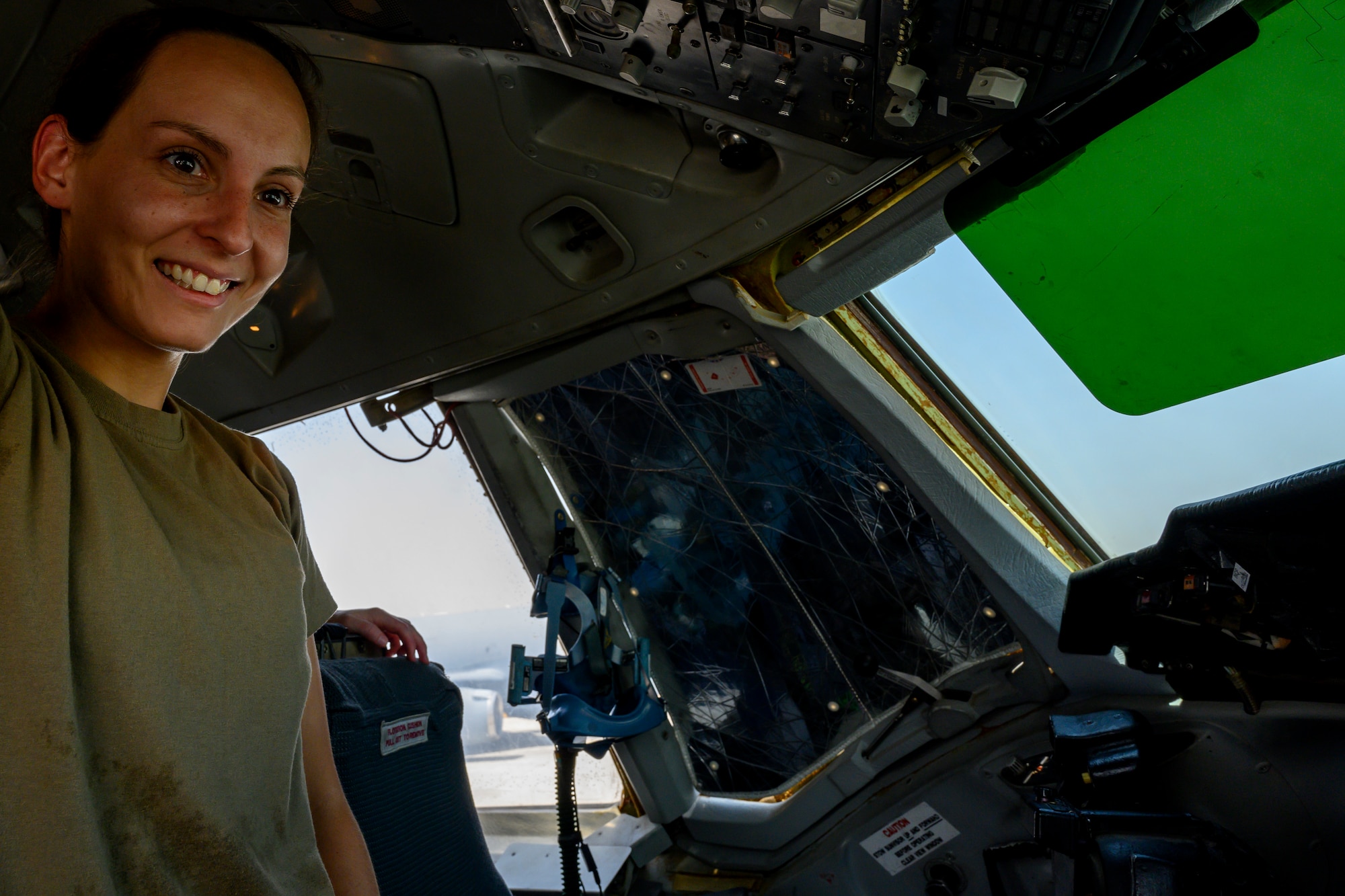 Female pilot in aircraft cockpit is smiling