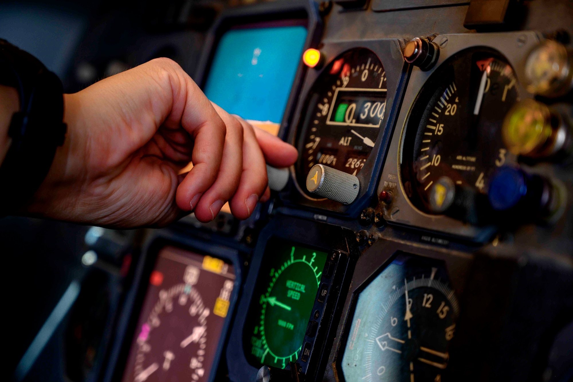 close up of hand adjusting controls on aircraft