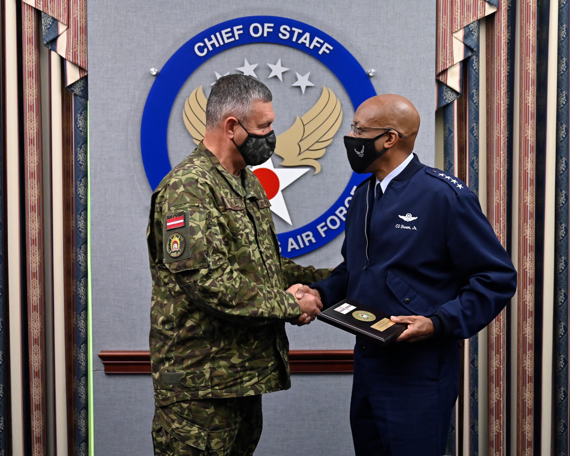 Air Force Chief of Staff Gen. CQ Brown, Jr. shakes hands with Lt. Gen. Leonids Kalnins, Latvia chief of defense