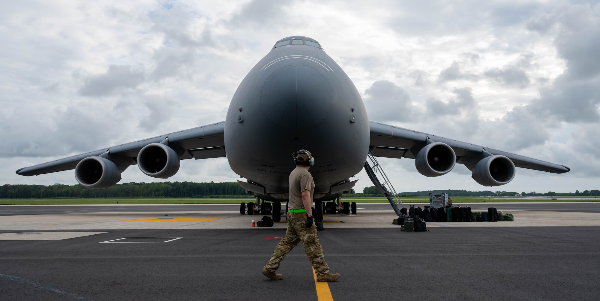 Staff Sgt. Ulysses Arango, 436th Maintenance Squadron flying crew chief, performs a walk-around pre-flight check on a C-5M Super Galaxy before takeoff to Hamid Karzai International Airport, Afghanistan from Dover Air Force Base, Delaware, Aug. 16, 2021. Air Mobility Airmen play a key role in facilitating the safe departure and relocation of U.S. citizens, Special Immigration Visa recipients, and vulnerable Afghan populations from Afghanistan. (U.S. Air Force photo by Senior Airman Faith Schaefer)