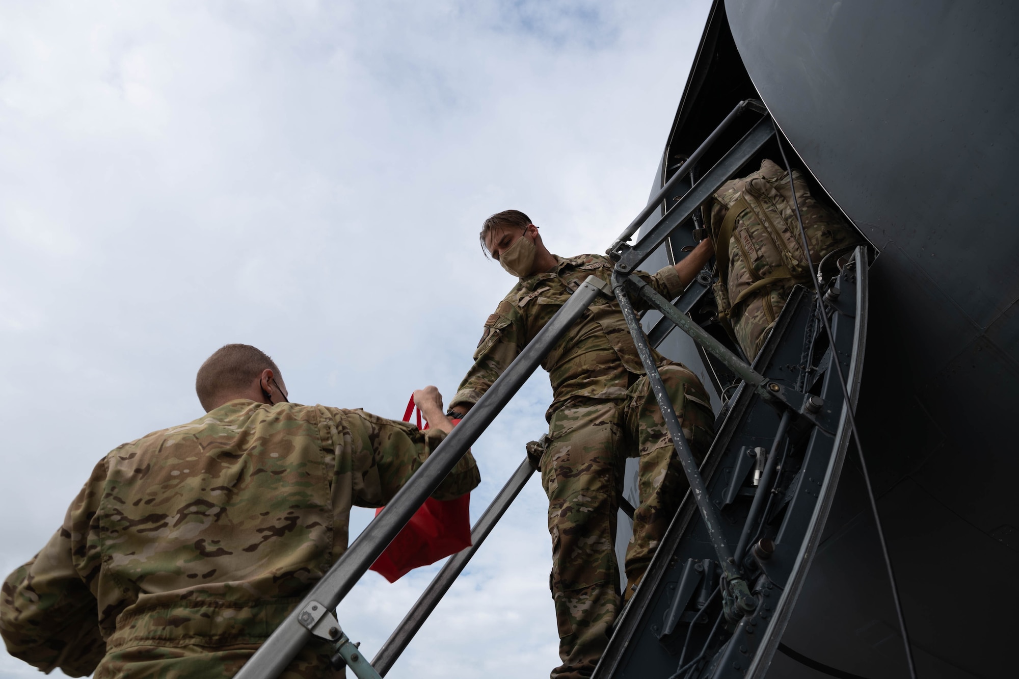 First Lt. Cole Wolf, right, and Maj. Zackery Williams, both 9th Airlift Squadron pilots, load bags onto a C-5M Super Galaxy before takeoff to Hamid Karzai International Airport, Afghanistan from Dover Air Force Base, Delaware, Aug. 16, 2021. Air Mobility Airmen play a key role in facilitating the safe departure and relocation of U.S. citizens, Special Immigration Visa recipients, and vulnerable Afghan populations from Afghanistan. (U.S. Air Force photo by Senior Airman Faith Schaefer)