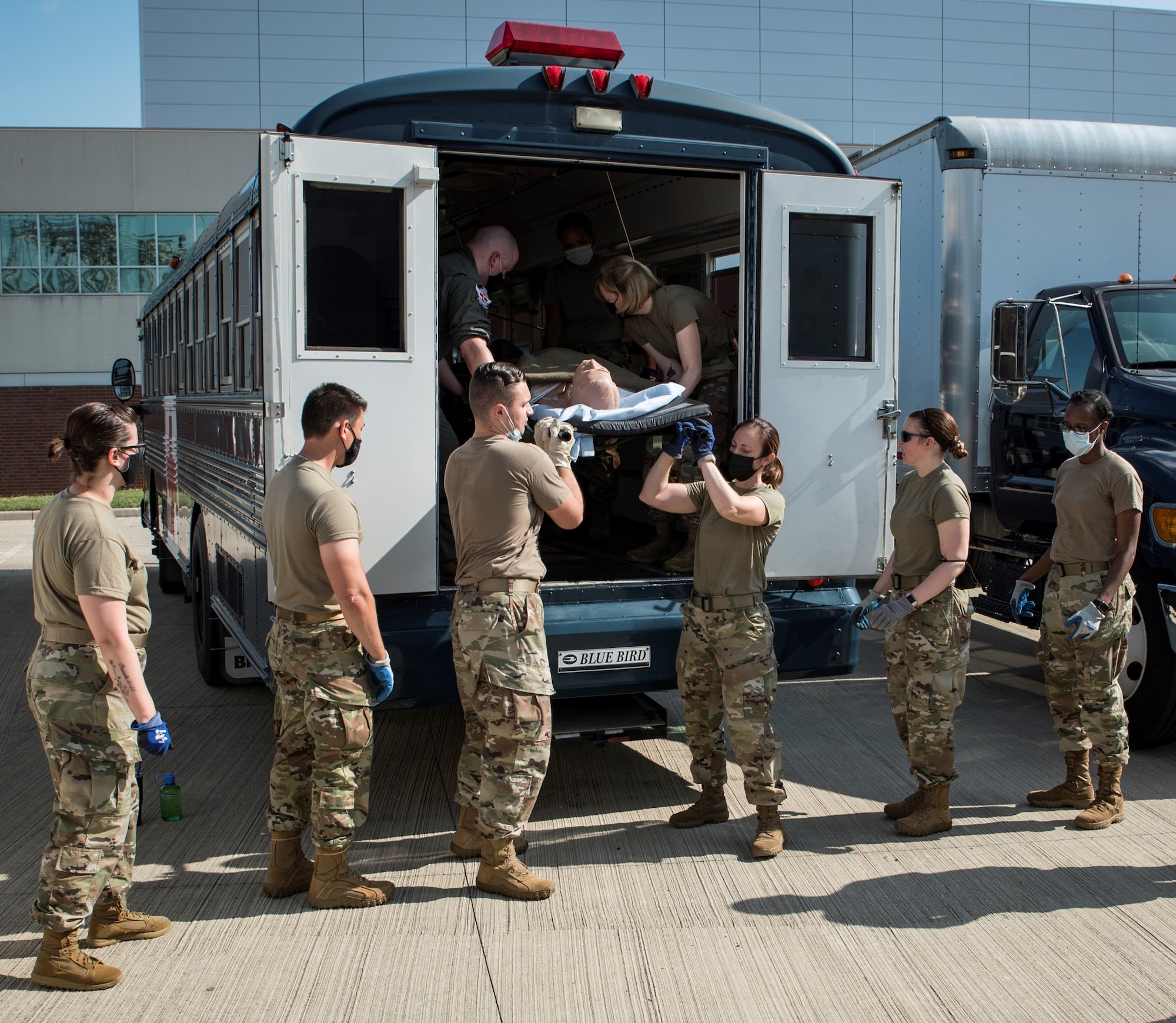 Medics from the 88th Medical Group unload a patient manikin from the AMBUS during deployment training Aug. 12 provided by aeromedical evacuation instructors at the U.S. Air Force School of Aerospace Medicine, part of the Air Force Research Laboratory’s 711th Human Performance Wing. (U.S. Air Force photo/Richard Eldridge)