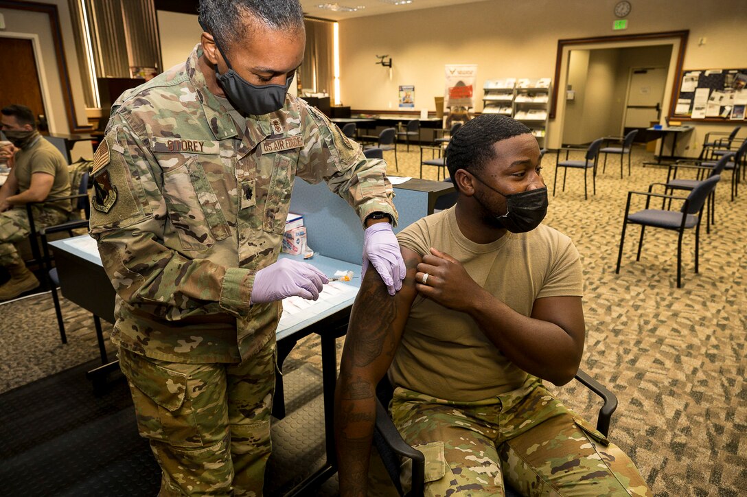 Senior Airman Rendall Powell, 412th Test Wing, receives a COVID-19 vaccination shot from Lt. Col. Yvonne Storey, 412th Medical Group, at the Airman and Family Readiness Center on Edwards Air Force Base, California, Aug. 25. Secretary of Defense Lloyd J. Austin III issued a memorandum directing mandatory COVID-19 vaccinations for service members. John F. Kirby, Pentagon press secretary, said only Food and Drug Administration-approved vaccines will be mandatory. (Air Force photo by Katherine Franco)