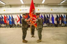Indian Head, Maryland (July 30, 2021) -- U.S. Marine Corps Col. Donald J. Riley Jr. outgoing Commanding Officer of the Chemical Biological Incident Response Force (CBIRF), passes the CBIRF guidon to U.S. Marine Corps Col. Dean A. Schulz, oncoming commander of CBIRF, during the CBIRF change of command ceremony at Naval Support Facility Indian Head, Md. The ceremony signifies the transfer of command authority and responsibility from Riley to Col. Dean A. Schulz. (U.S. Marine Corps photo by SSgt Kristian S. Karsten/Released)