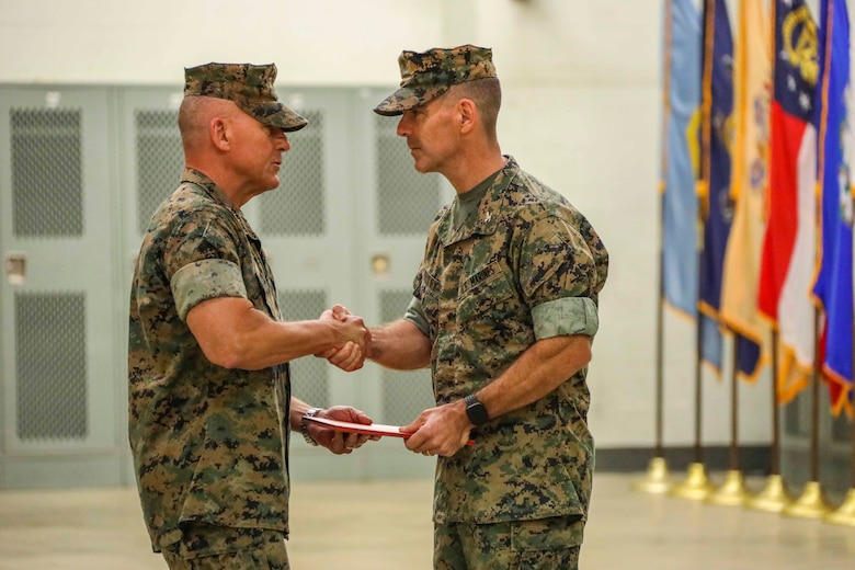 Indian Head, Maryland (July 30, 2021) -- U.S. Marine Corps Lt. Gen. Robert F. Hedelund, Commanding General, Fleet Marine Force Atlantic (FMFLANT), and Commander, U.S. Marine Corps Forces Command (MARFORCOM), U.S. Marine Corps Forces Northern Command (MARFORNORTH) awards the Meritorious Service Medal to U.S. Marine Corps Col. Donald J. Riley Jr. outgoing Commanding Officer of the Chemical Biological Incident Response Force (CBIRF), during the CBIRF change of command ceremony at Naval Support Facility Indian Head, Md. The ceremony signifies the transfer of command authority and responsibility from Riley to Col. Dean A. Schulz. (U.S. Marine Corps photo by SSgt Kristian S. Karsten/Released)