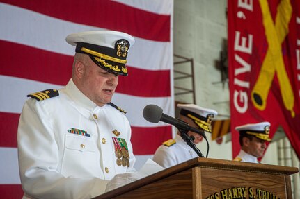 Cmdr. Chris Hester delivers an invocation during a change of command ceremony for Commander, Carrier Strike Group (CSG) 8 in the hangar bay of the Nimitz-class aircraft carrier USS Harry S. Truman (CVN 75).
