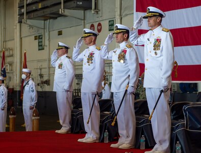 Rear Adm. Ryan Scholl, commander, Carrier Strike Group (CSG) 8, delivers remarks during a change of command ceremony for CSG-8 in the hangar bay of the Nimitz-class aircraft carrier USS Harry S. Truman (CVN 75).