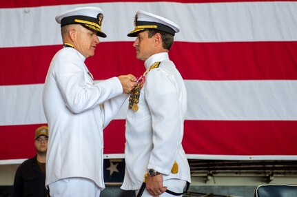 Rear Adm. Ryan Scholl, commander, Carrier Strike Group (CSG) 8, delivers remarks during a change of command ceremony for CSG-8 in the hangar bay of the Nimitz-class aircraft carrier USS Harry S. Truman (CVN 75).