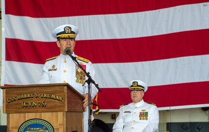 Rear Adm. Ryan Scholl, commander, Carrier Strike Group (CSG) 8, delivers remarks during a change of command ceremony for CSG-8 in the hangar bay of the Nimitz-class aircraft carrier USS Harry S. Truman (CVN 75).