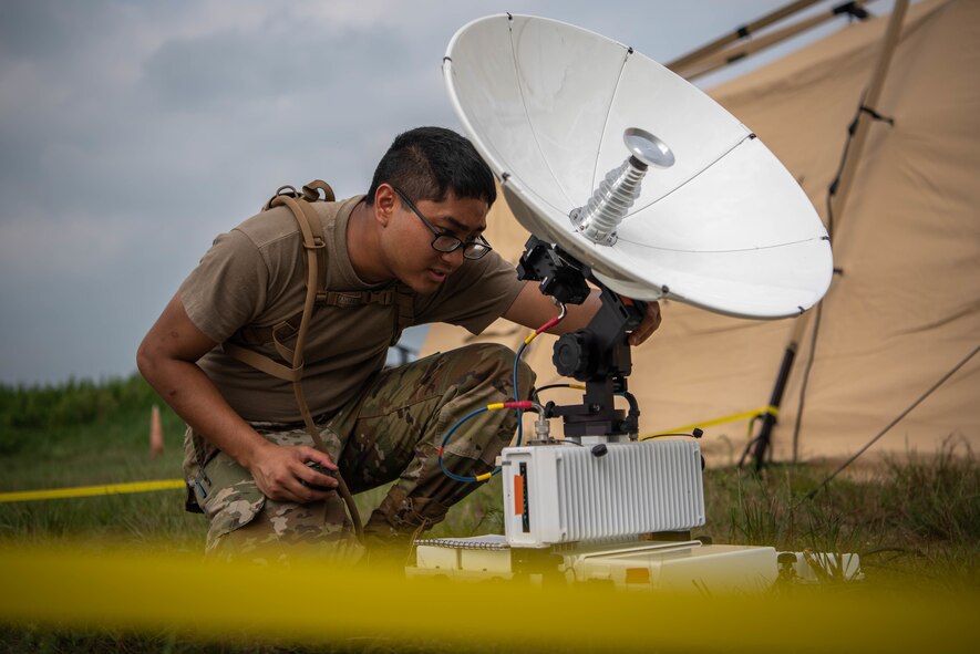 Photo of Airmen setting up a satelite
