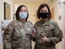 Chief Master Sergeant of the Air Force JoAnne S. Bass, right, and Tech. Sgt. Renee Benningfield, 374th Medical Group NCO in charge of medical services, pose for a photo at Yokota Air Base, Japan, Aug. 26, 2021. Benningfield received a coin from Bass for her part in executing the local COVID-19 vaccine plan. (U.S. Air Force photo by Senior Airman Brieana E. Bolfing)