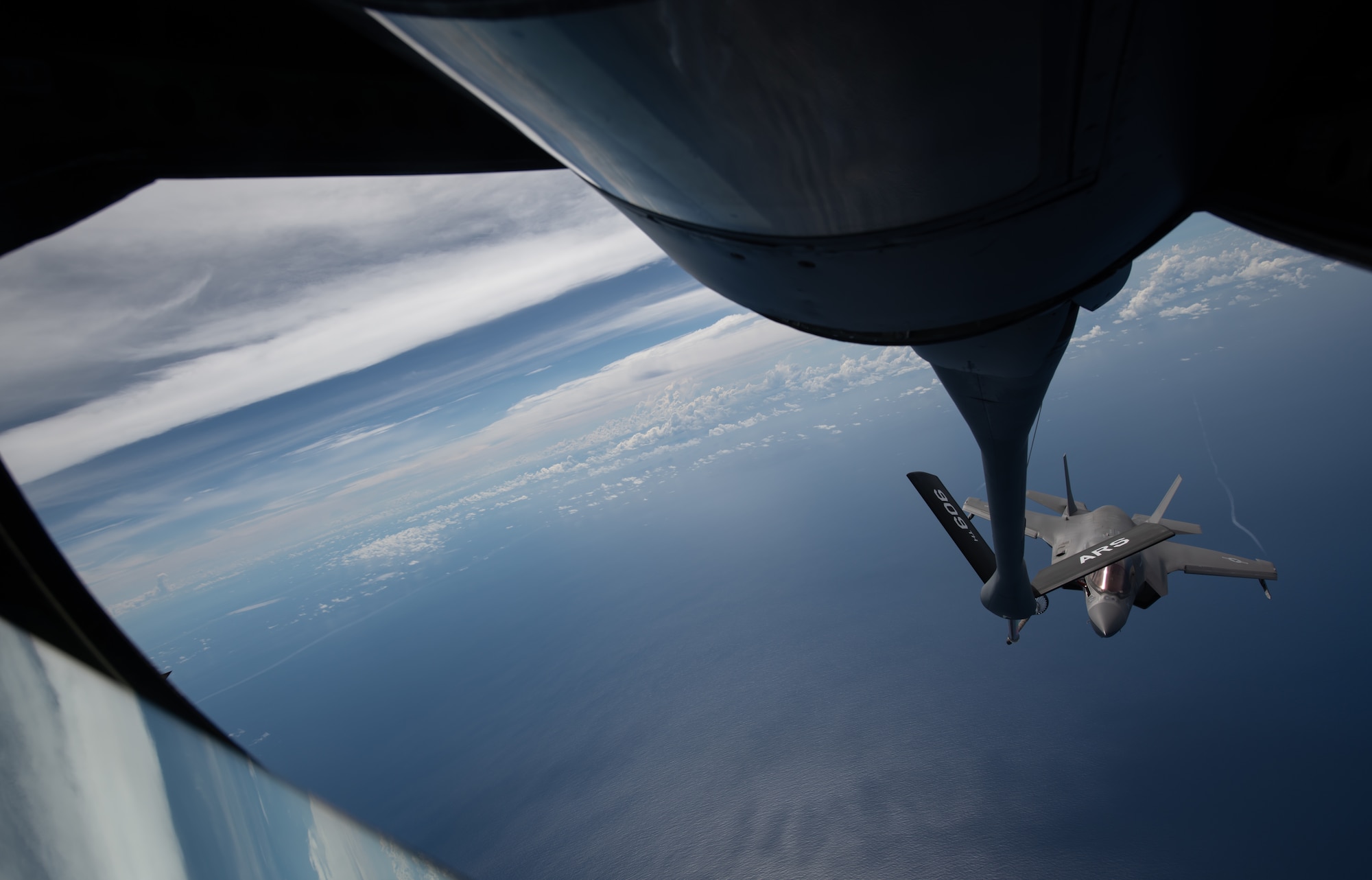 A U.S. Marine Corps F-35B Lightning II, Marine Fighter Attack Squadron based out of Marine Corps Air Station MCAS Iwakuni, Japan, flies into position to receive fuel from a KC-135 Stratotanker assigned to the 909th Air Refueling Squadron, Kadena Air Base, Japan during a Large Scale Global Exercise 21 mission over the western Pacific Ocean, Aug. 18, 2021. The U.S. has the ability to operate from the sanctuary of bases across the region and projecting sustained combat power.  (U.S. Air Force photo by Tech. Sgt. Micaiah Anthony)